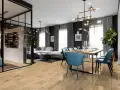 Nowoczesny salon z jadalnią, gdzie spc. drewniana podłoga tworzy ciepłą bazę dla błękitnych krzeseł i szarej sofy.